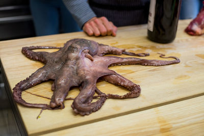 Close-up of man preparing food on cutting board