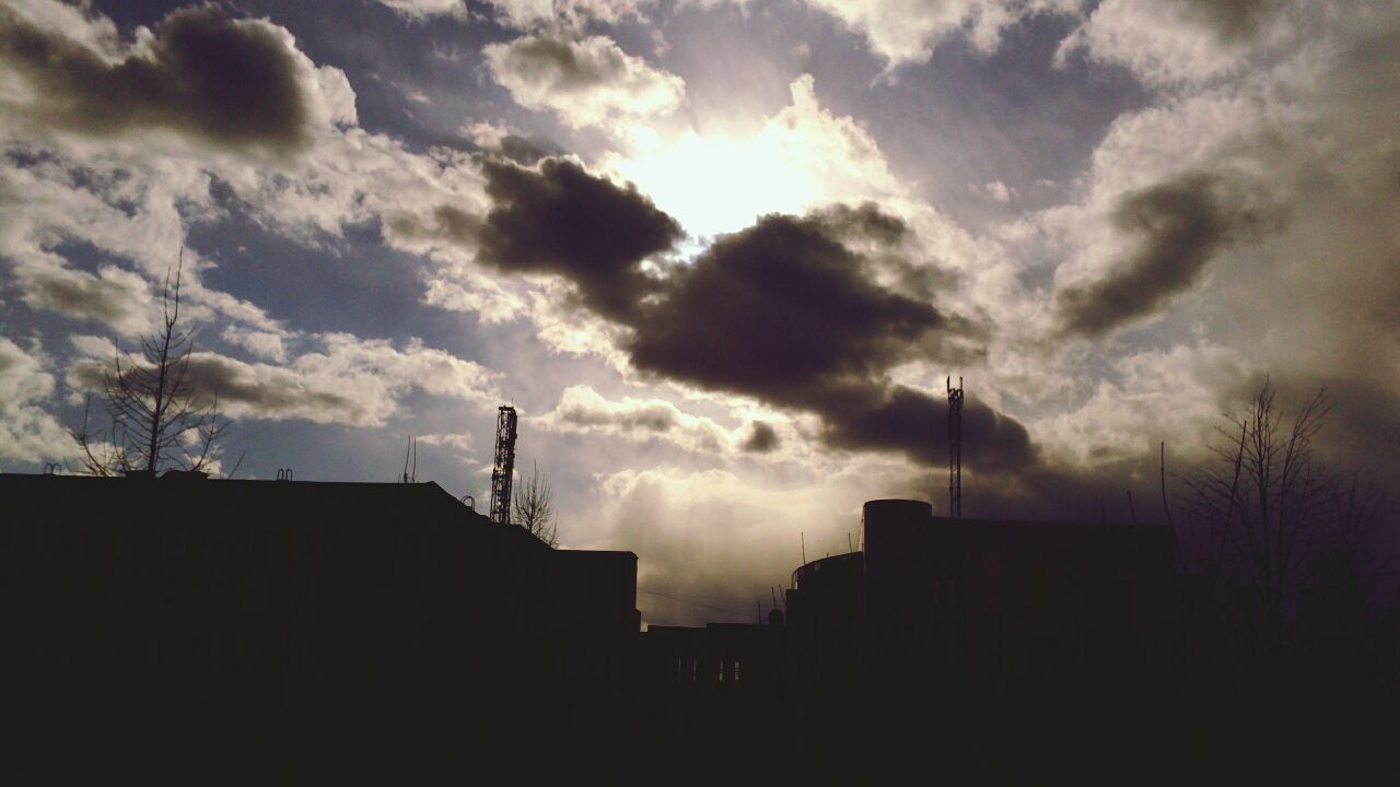 building exterior, architecture, built structure, sky, silhouette, cloud - sky, city, low angle view, cloudy, building, residential building, sunset, cloud, residential structure, outdoors, house, sunlight, no people, dusk, weather