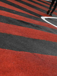 Low section of person crossing road