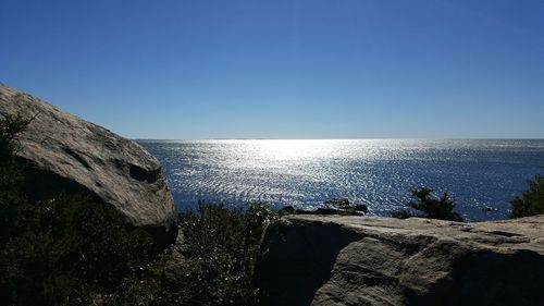 Scenic view of sea against clear blue sky