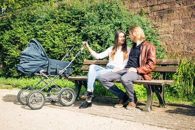 Woman sitting on bench in park