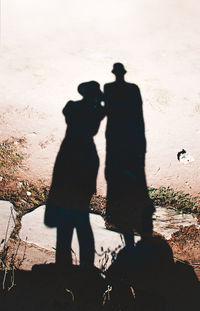 Shadow of man and people standing on floor