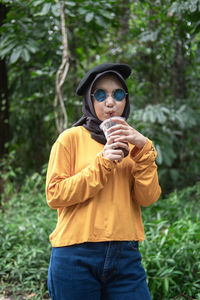 Portrait of young woman standing outdoors