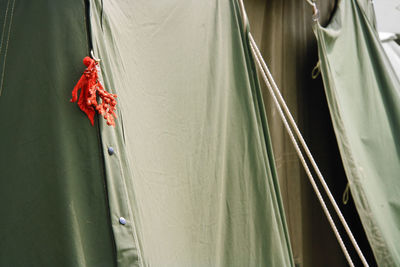 Detail of the military tent with a red christmas decoration hanging on it