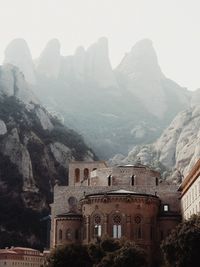 Buildings against mountain range