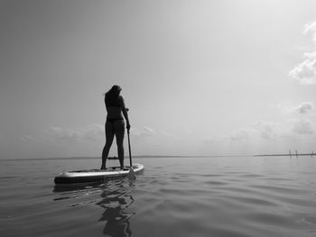 Rear view of a woman in calm sea