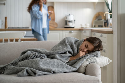 Young woman lying on bed at home