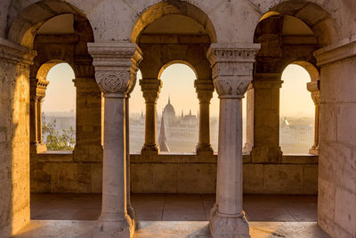 City seen through window during sunset