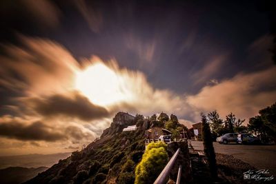 View of road against cloudy sky at sunset