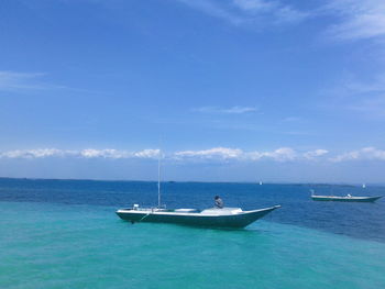 Boats in sea against sky