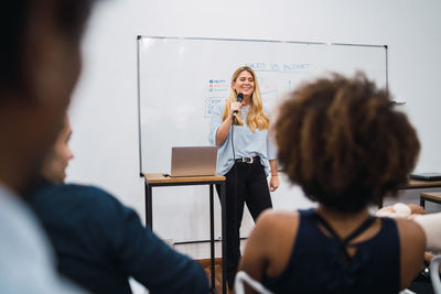 Businesswoman giving presentation in board room