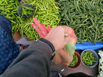 Low section of woman buying vegetables