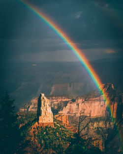 Scenic view of rainbow over rocks