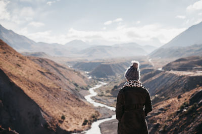 Rear view of man standing on mountain