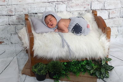 High angle view of baby sleeping in bed