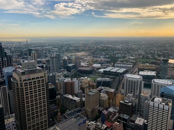 High angle view of modern buildings against sky during sunset