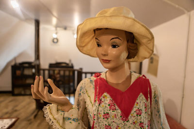 Portrait of woman wearing hat at home