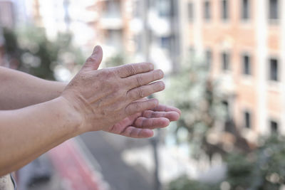 Cropped image of man holding hands