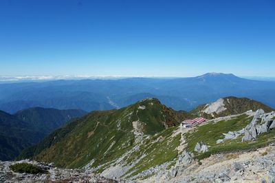 Scenic view of mountains against clear blue sky