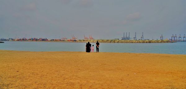 People on beach against sky