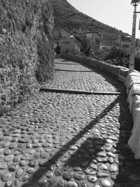 Man walking on cobblestone