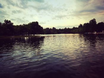 Scenic view of lake against sky at sunset