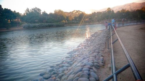 Scenic view of river at sunset