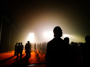 Rear view of silhouette people standing against sky