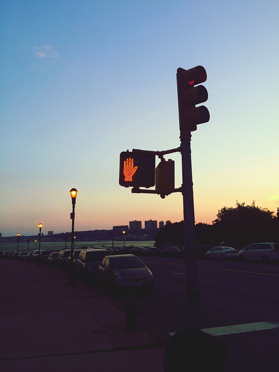 street, road sign, street light, road, sunset, transportation, car, land vehicle, guidance, outdoors, sky, vehicle, symbol