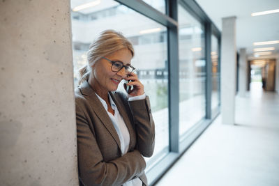 Businesswoman talking on mobile phone in office