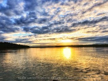 Scenic view of lake against sky during sunset