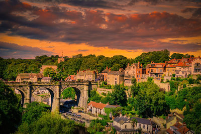 High angle view of townscape against orange sky