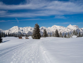 Scenic view of snow covered mountains against sky