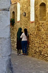 Rear view of women walking in building