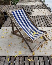 High angle view of deck chair at waterfront