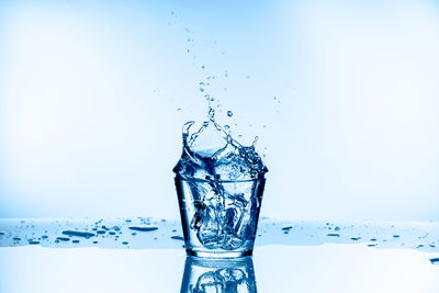 Close-up of splashing water against white background