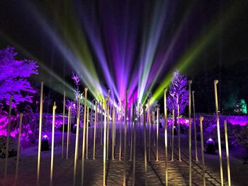 Illuminated lights against sky at night