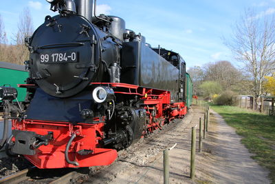 Train on railroad track against sky