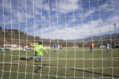 Men playing soccer on field