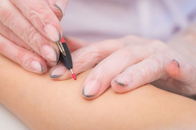 Cropped hand of doctor examining patient