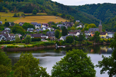 Scenic view of lake by buildings in city