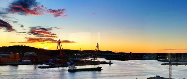 Boats in harbor at sunset