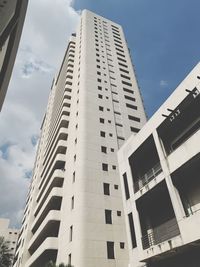 Low angle view of buildings against cloudy sky