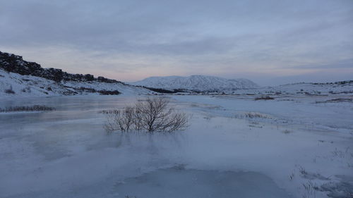 Scenic view of snowcapped mountains against sky overlooking frozen lake