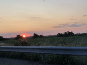 Scenic view of field against sky during sunset