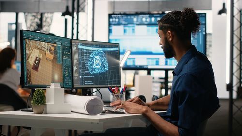 Side view of man working at office