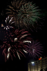 Low angle view of firework display at night