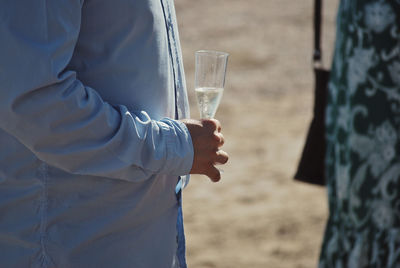 Midsection of man holding drink