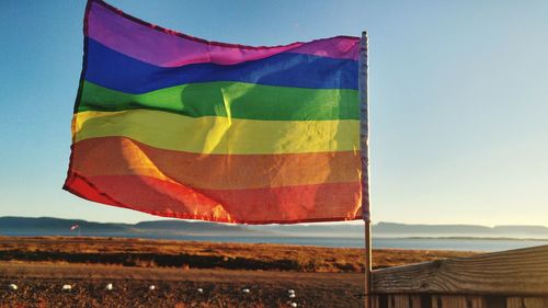 Multi colored flag against clear sky