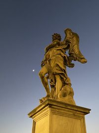 Low angle view of statue against sky